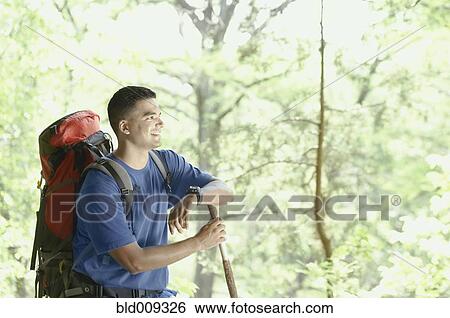 Young man backpacking in forest View Large Photo Image Stock Photograph - Young man backpacking in forest. Fotosearch