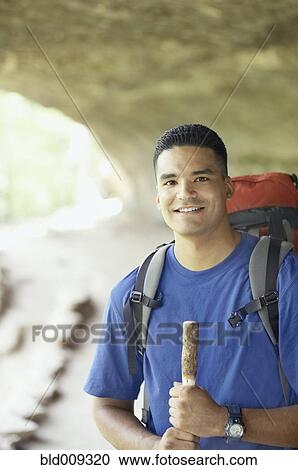 Young man hiking on a trail View Large Photo Image Stock Image - Young man hiking on a trail. Fotosearch