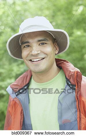 Young man wearing a hat outdoors View Large Photo Image Stock Photo - Young man wearing a hat outdoors. Fotosearch