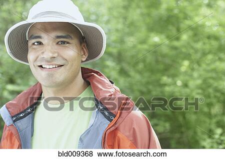 Stock Photo - Young man wearing a hat outdoors. Fotosearch