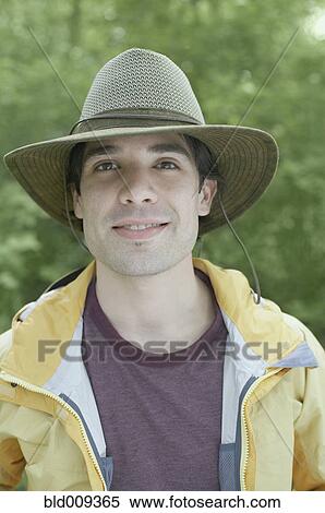 Young man wearing a hat outdoors View Large Photo Image Stock Photography - Young man wearing a hat outdoors. Fotosearch