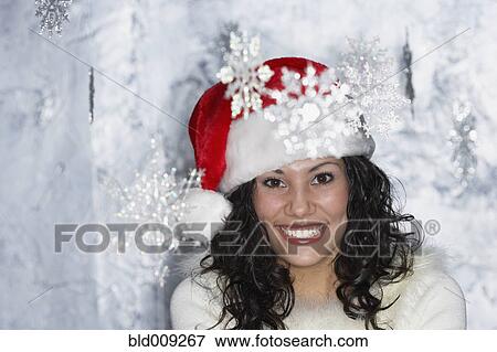 Young woman dressed in a Santa hat View Large Photo Image Stock Photo - Young woman dressed in a Santa hat. Fotosearch
