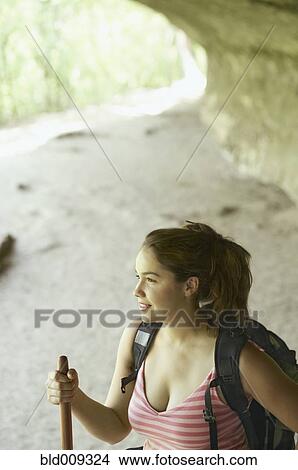 Picture - Young woman hiking in a canyon. Fotosearch