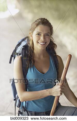 Stock Image - Young woman hiking in a canyon. Fotosearch