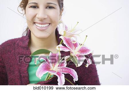 Stock Photo - Young woman holding flowers. Fotosearch