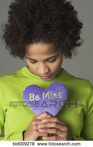 Young woman holding heart View Large Photo Image Stock Photo - Young woman holding heart. Fotosearch