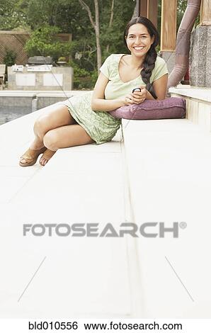 Young woman holding mobile phone View Large Photo Image Stock Photograph - Young woman holding mobile phone. Fotosearch