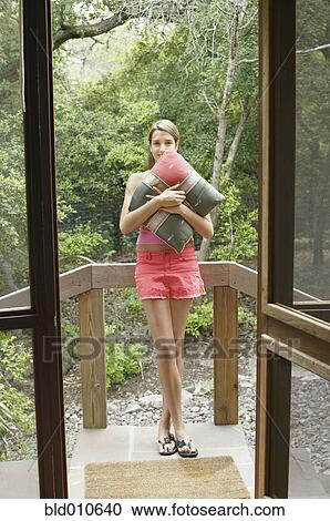 Young woman holding pillow View Large Photo Image Stock Image - Young woman holding pillow. Fotosearch