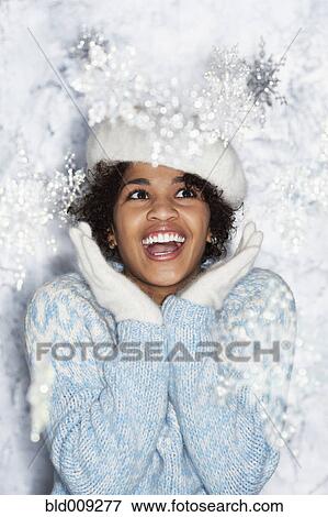 Stock Photo - Young woman in winter wonderland scene. Fotosearch