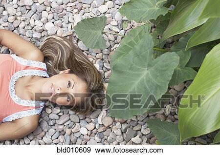 Young woman lying on back View Large Photo Image Stock Photo - Young woman lying on back. Fotosearch