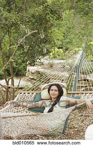Stock Photography - Young woman lying on hammock. Fotosearch