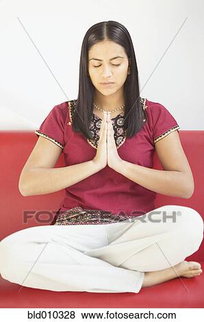 Stock Photo - Young woman practicing yoga. Fotosearch