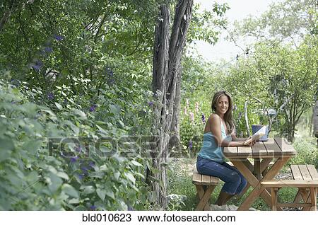Young woman reading book outside View Large Photo Image Stock Image - Young woman reading book outside. Fotosearch