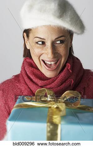 Stock Photograph - Young woman receiving gift. Fotosearch