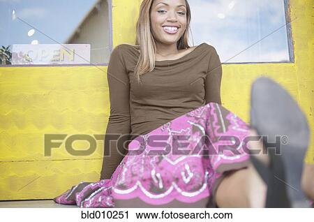 Young woman sitting outside View Large Photo Image Stock Image - Young woman sitting outside. Fotosearch