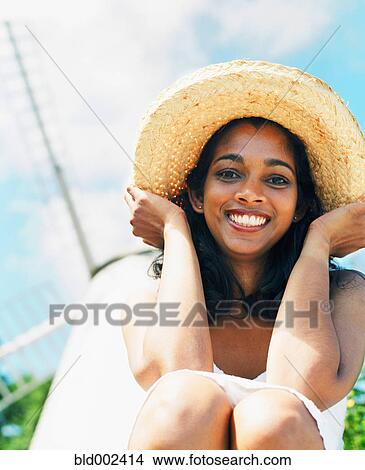 Young woman smiling with sun hat View Large Photo Image Picture - Young woman smiling with sun hat. Fotosearch