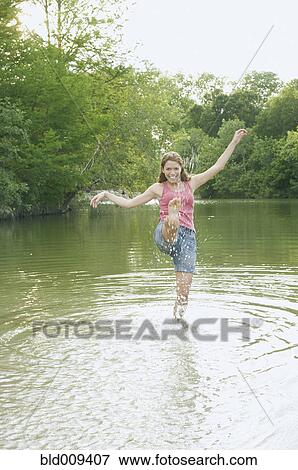 Stock Photo - Young woman splashing water. Fotosearch
