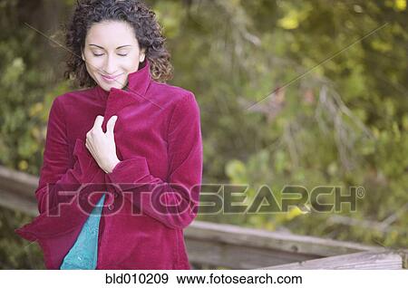 Stock Photo - Young woman wearing a coat. Fotosearch
