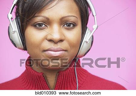 Young woman wearing headphones View Large Photo Image Stock Image - Young woman wearing headphones. Fotosearch