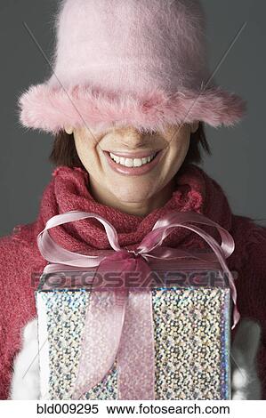 Young woman with hat over eyes View Large Photo Image Stock Photography - Young woman with hat over eyes. Fotosearch