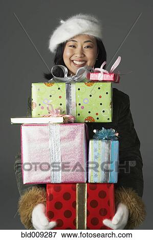Young woman with stack of gifts View Large Photo Image Stock Photo - Young woman with stack of gifts. Fotosearch