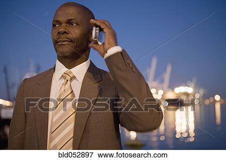 African American businessman talking on cell phone View Large Photo Image Stock Photo - African American businessman talking on cell phone. Fotosearch