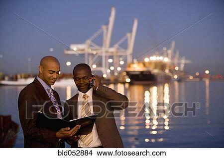 African American businessmen looking at paperwork View Large Photo Image Picture - African American businessmen looking at paperwork. Fotosearch