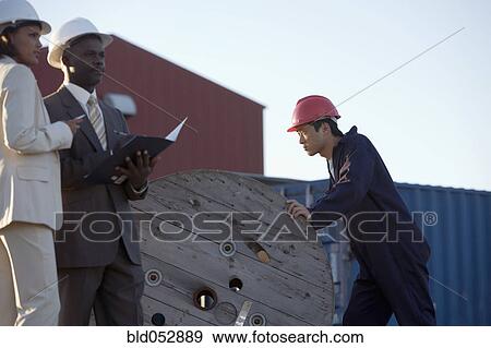 Stock Photo - African American businesspeople at commercial pier. Fotosearch