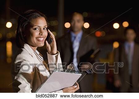 Stock Photo - African American businesswoman talking on cell phone. Fotosearch