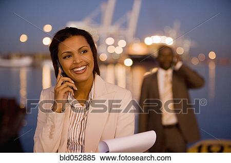 Stock Photography - African American businesswoman talking on cell phone. Fotosearch