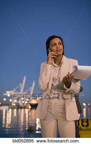 Stock Photography - African American businesswoman talking on cell phone. Fotosearch