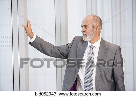 African businessman leaning on wall View Large Photo Image Stock Photo - African businessman leaning on wall. Fotosearch
