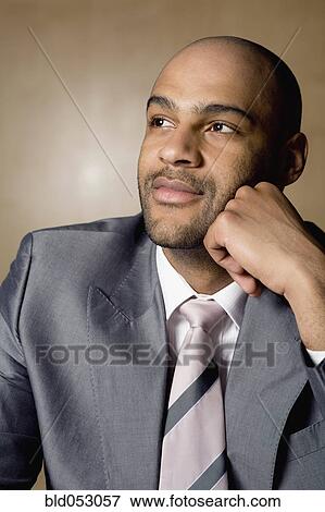 Stock Photo - African businessman looking to side. Fotosearch