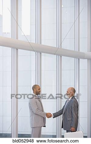 Stock Photo - African businessmen shaking hands. Fotosearch