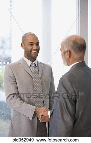 Stock Photo - African businessmen shaking hands. Fotosearch
