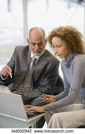 African businesspeople looking at laptop View Large Photo Image Stock Image - African businesspeople looking at laptop. Fotosearch