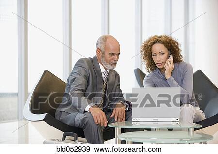 African businesspeople looking at laptop View Large Photo Image Stock Photo - African businesspeople looking at laptop. Fotosearch