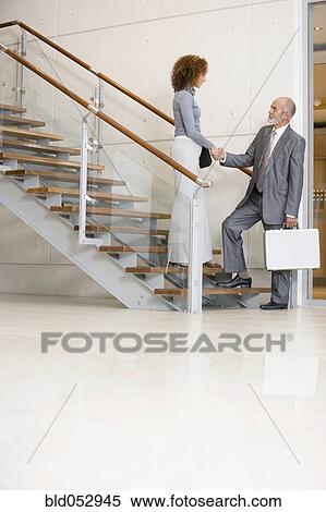 Stock Photography - African businesspeople shaking hands. Fotosearch