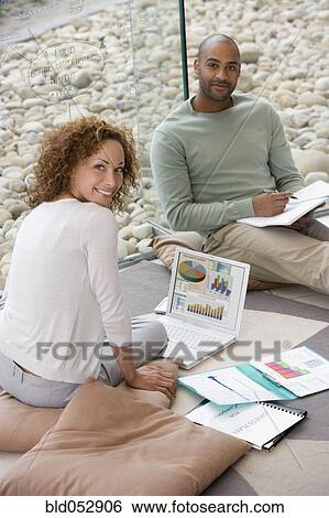 Stock Photograph - African businesspeople working on floor. Fotosearch