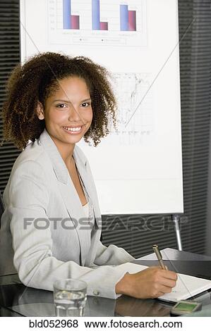 Stock Photo - African businesswoman at conference table. Fotosearch