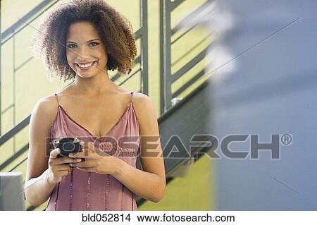 Picture - African businesswoman holding electronic organizer. Fotosearch