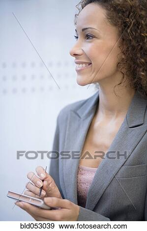 African businesswoman holding electronic organizer View Large Photo Image Stock Photo - African businesswoman holding electronic organizer. Fotosearch