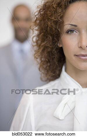Stock Image - African businesswoman in front of coworker. Fotosearch