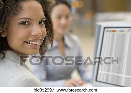 African businesswoman next to computer View Large Photo Image Stock Photo - African businesswoman next to computer. Fotosearch