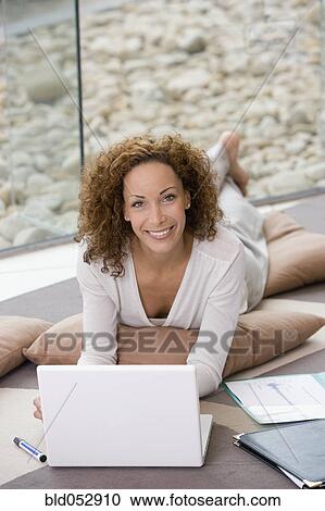 Stock Image - African businesswoman next to laptop. Fotosearch