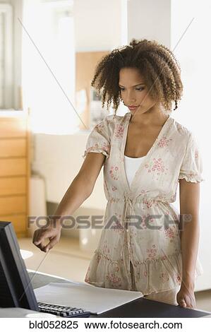 African businesswoman pointing at computer View Large Photo Image Stock Photography - African businesswoman pointing at computer. Fotosearch
