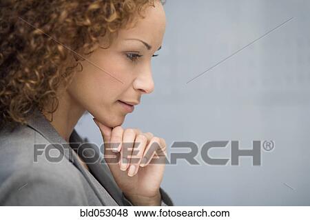 Stock Photo - African businesswoman resting chin on hand. Fotosearch