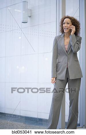 Stock Image - African businesswoman talking on cell phone. Fotosearch