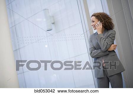 Stock Image - African businesswoman talking on cell phone. Fotosearch