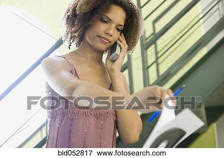 African businesswoman talking on telephone View Large Photo Image Stock Photo - African businesswoman talking on telephone. Fotosearch